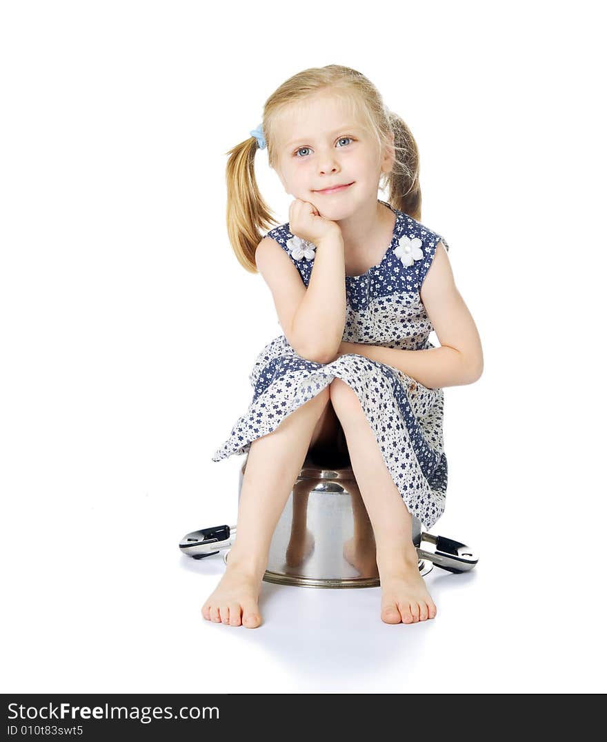 Little cute girl sitting over saucepan isolated