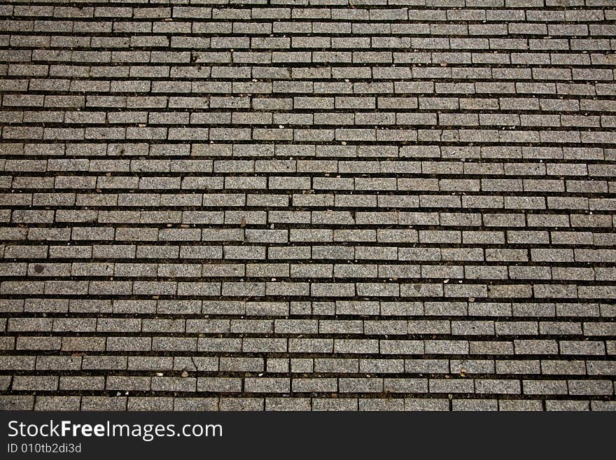 Stone design in Prague sidewalk. Background texture.