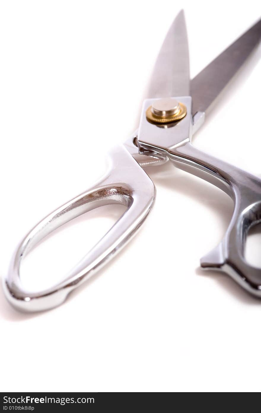 A pair of chrome dress shears or ceremonial scissors on a white background. A pair of chrome dress shears or ceremonial scissors on a white background