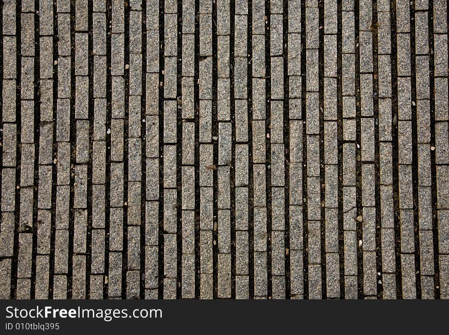 Stone design in Prague sidewalk. Background texture.