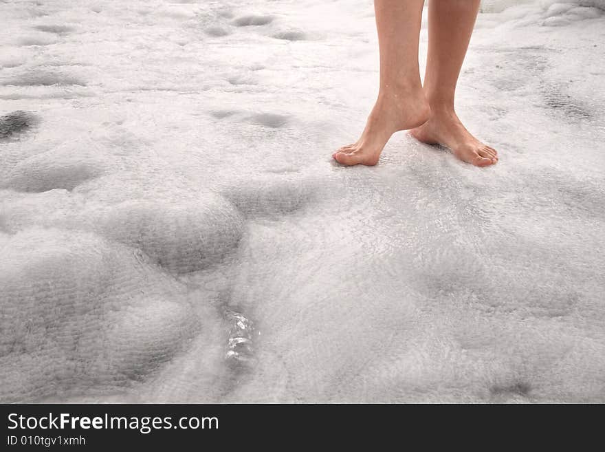 Woman legs on the white mineral surface in Pamukkale (Turkey). Woman legs on the white mineral surface in Pamukkale (Turkey)