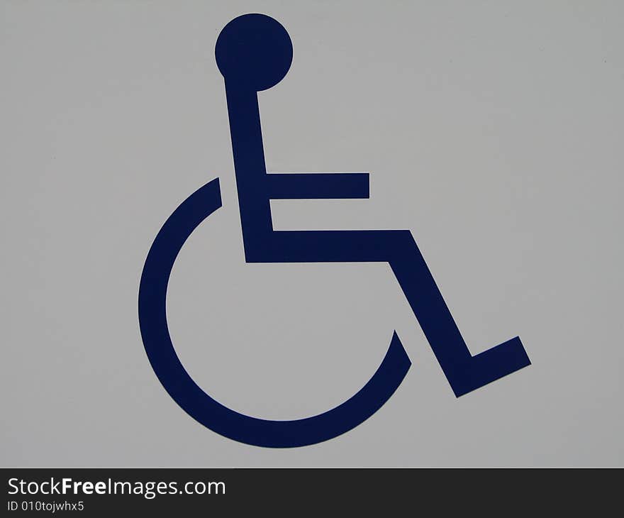 Blue wheelchair sign on a white wall