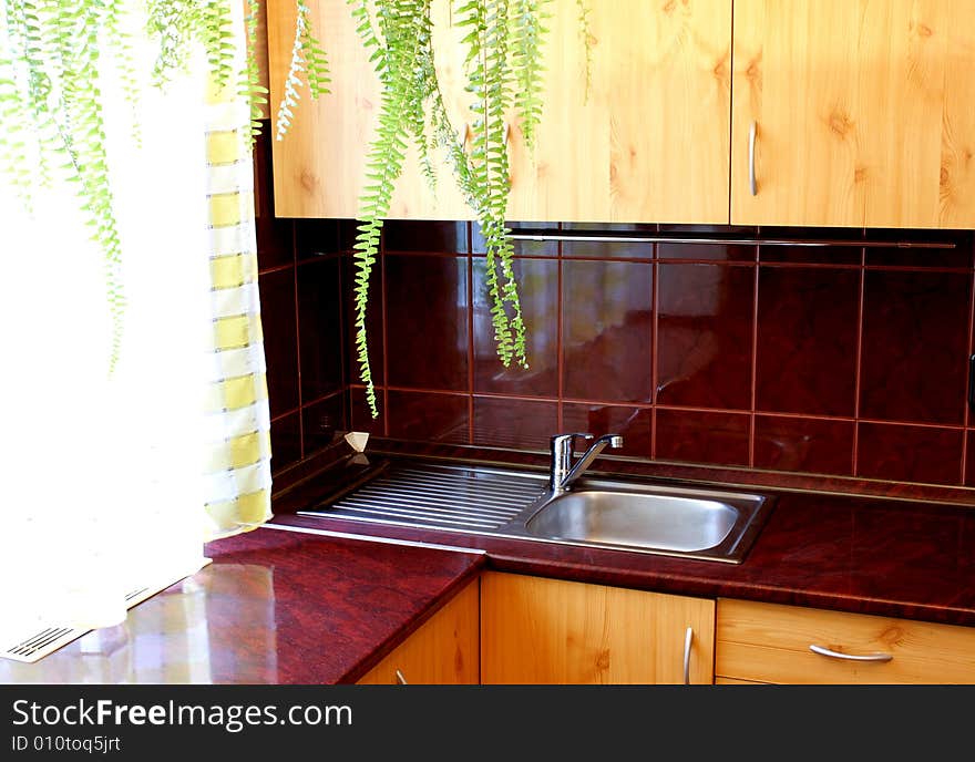 Kitchen detail with dark red floor tiles