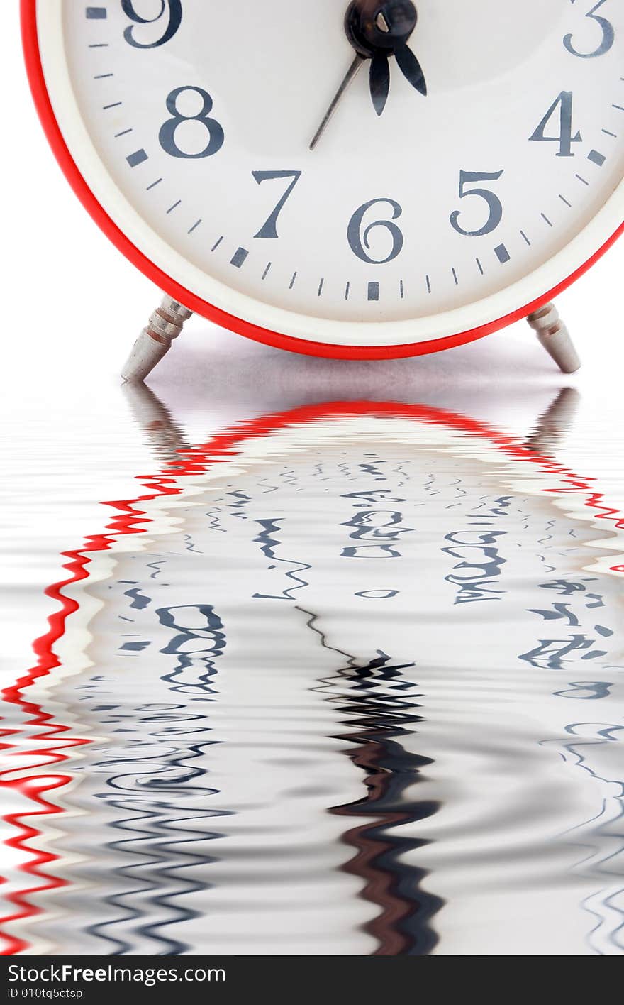 Old red alarm clock on a white background