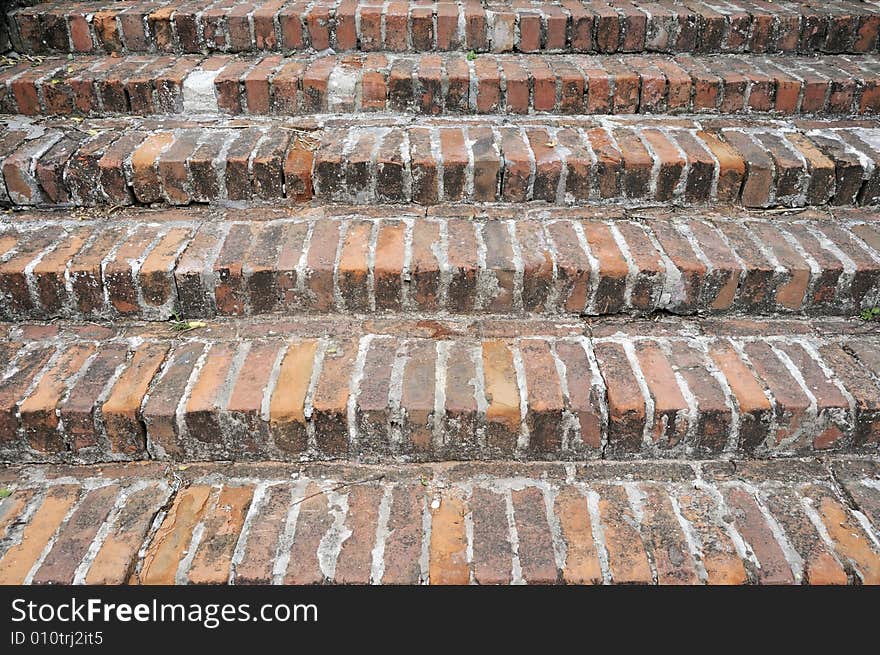 Old hand made red brick stairs