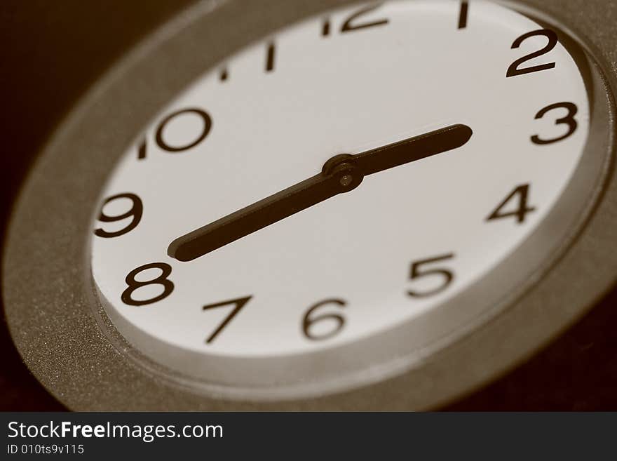 Macro-photo of an analog clock in sepia