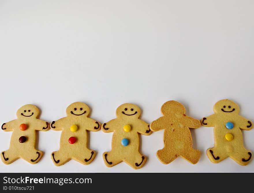 A row of shortbread men is joined by an indifferent one