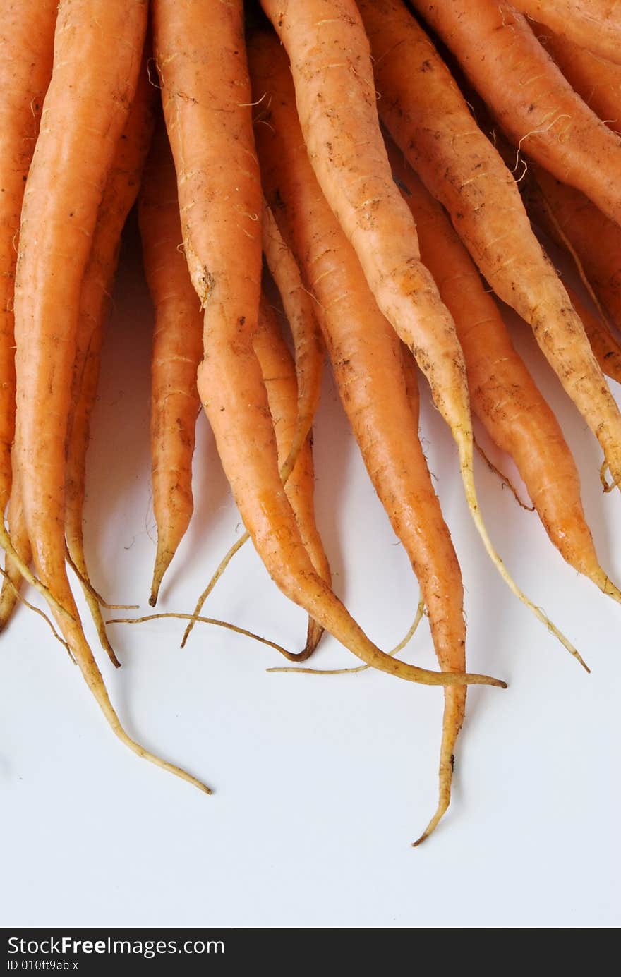 A bunch of carrots await washing and cooking. A bunch of carrots await washing and cooking