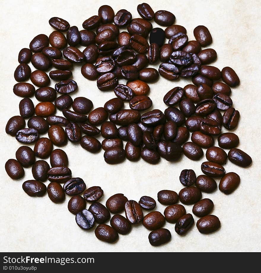 Happy smile made of fresh roasted black coffee beans. Happy smile made of fresh roasted black coffee beans