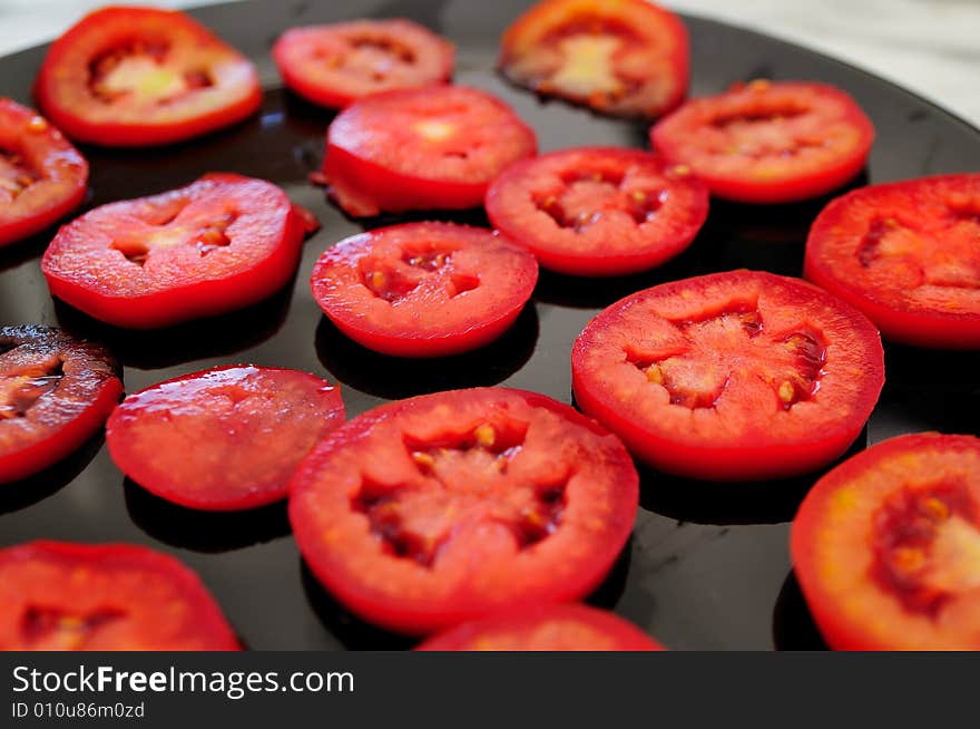 Sliced tomatoes composition in a kitchen. Sliced tomatoes composition in a kitchen