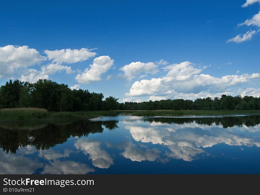 Tree's and cloud's reflecting off the waters surface. Tree's and cloud's reflecting off the waters surface