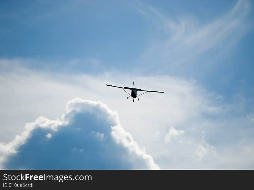 Airplane flying off into the clouds. Airplane flying off into the clouds