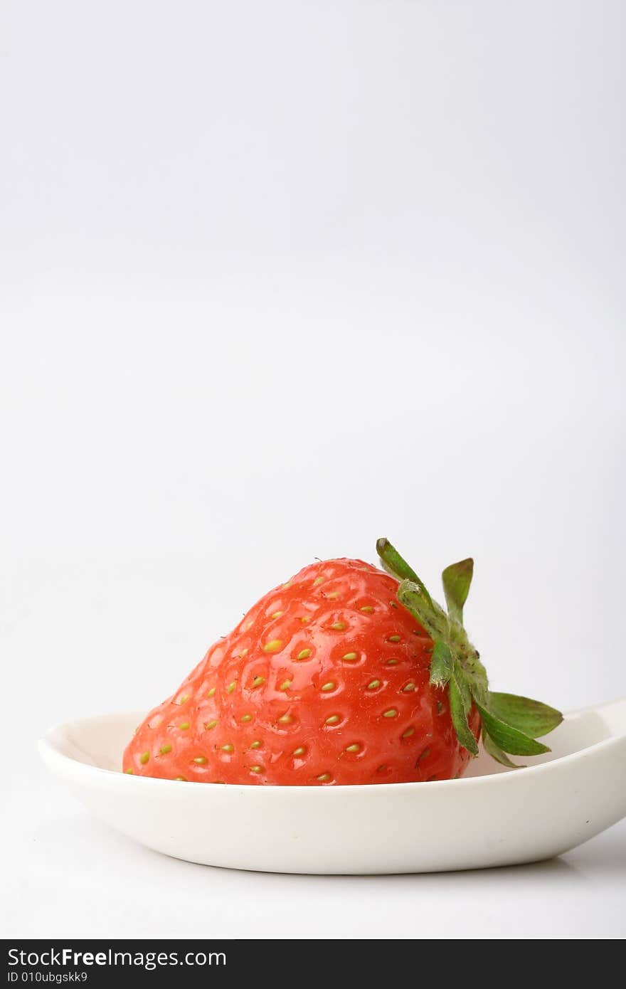 An appetizing strawberry on a white scoop