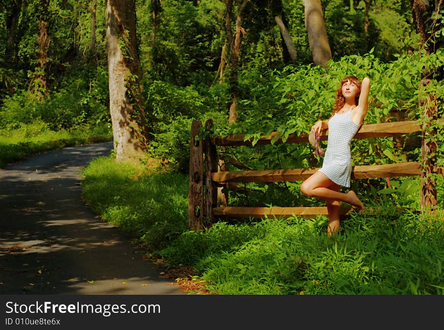 Beautiful woman lounging in the countryside. Beautiful woman lounging in the countryside.