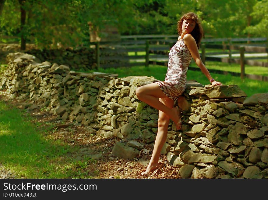 Beautiful woman lounging in the countryside. Beautiful woman lounging in the countryside.