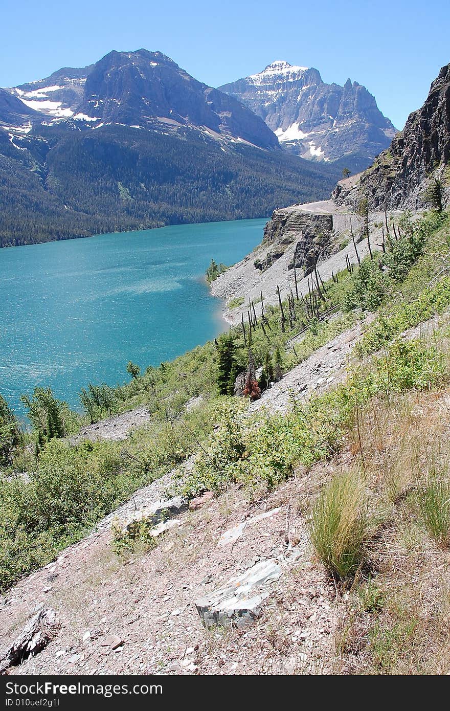 Landscapes of snow mountains, lake and sandy cliff in glacier national park, montana, usa. Landscapes of snow mountains, lake and sandy cliff in glacier national park, montana, usa