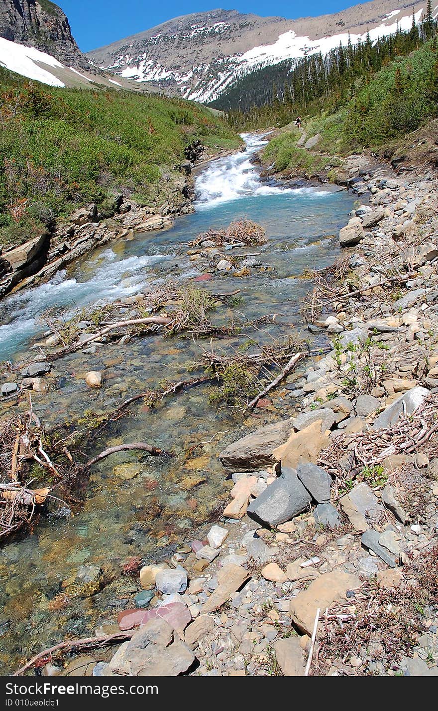 Snow mountain and hillside creek in glacier national park, montana, usa. Snow mountain and hillside creek in glacier national park, montana, usa