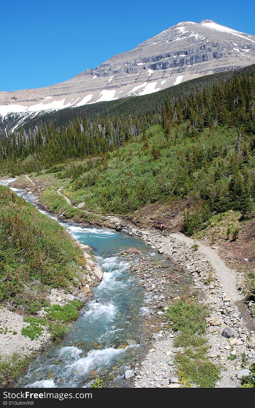 Snow mountain and hillside creek in glacier national park, montana, usa. Snow mountain and hillside creek in glacier national park, montana, usa