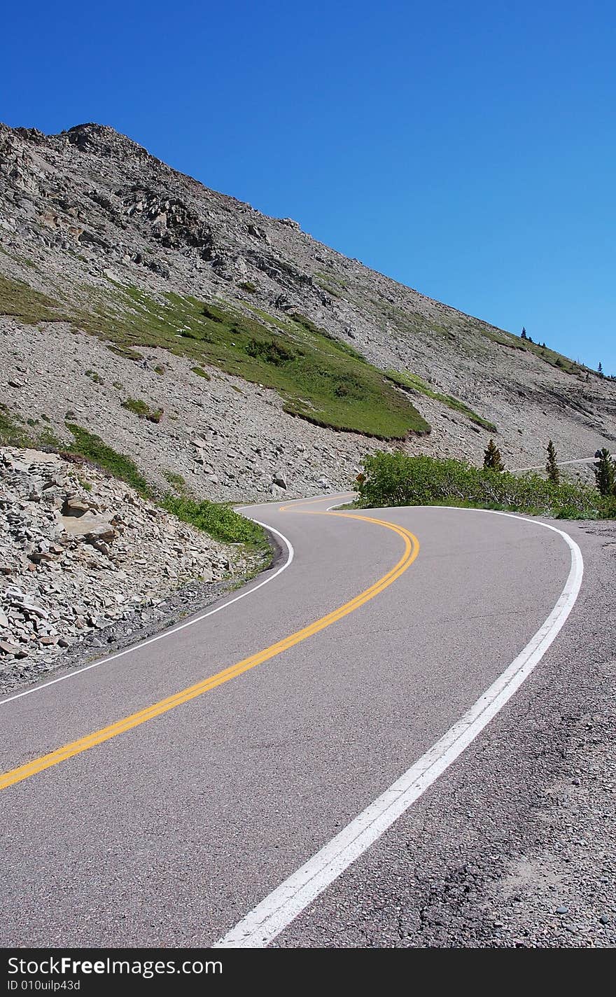 Sandy cliff and winding parkway in glacier national park, Montana, united states. Sandy cliff and winding parkway in glacier national park, Montana, united states