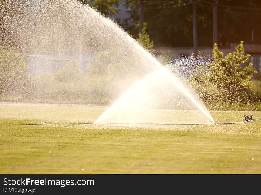 Fire hose badly leaking, outdoors. Fire hose badly leaking, outdoors