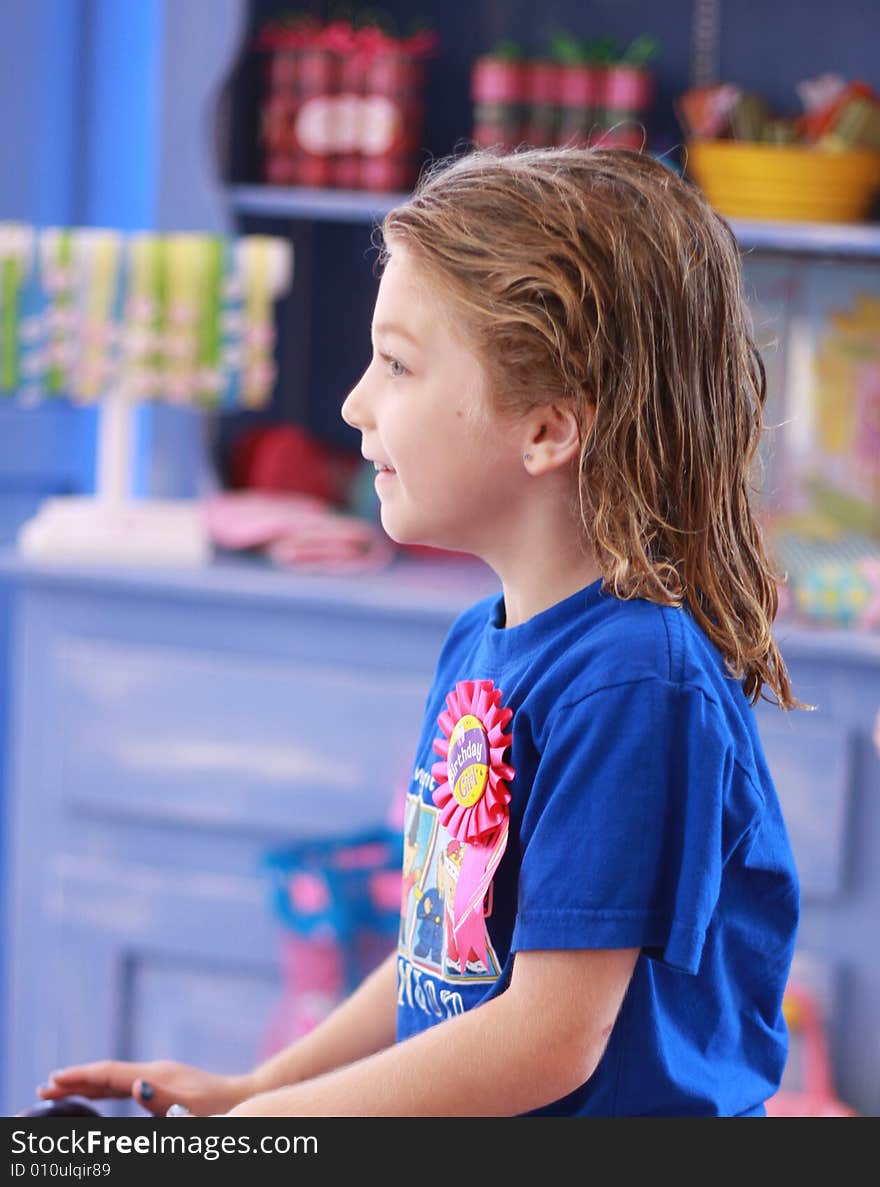 Little girl with wet hair waits to have her hair cut in boutique salon. Little girl with wet hair waits to have her hair cut in boutique salon.