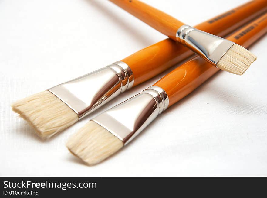 Three yellow brushes for drawing on white background (isolated)