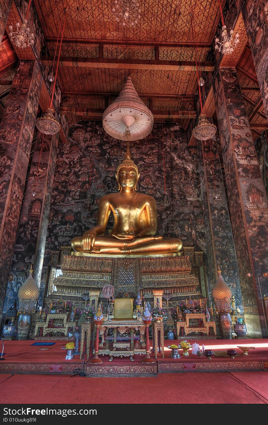 This is a HDR capture of the 8 meter high Buddha Shakyamuni at Wat Suthat in Bangkok.