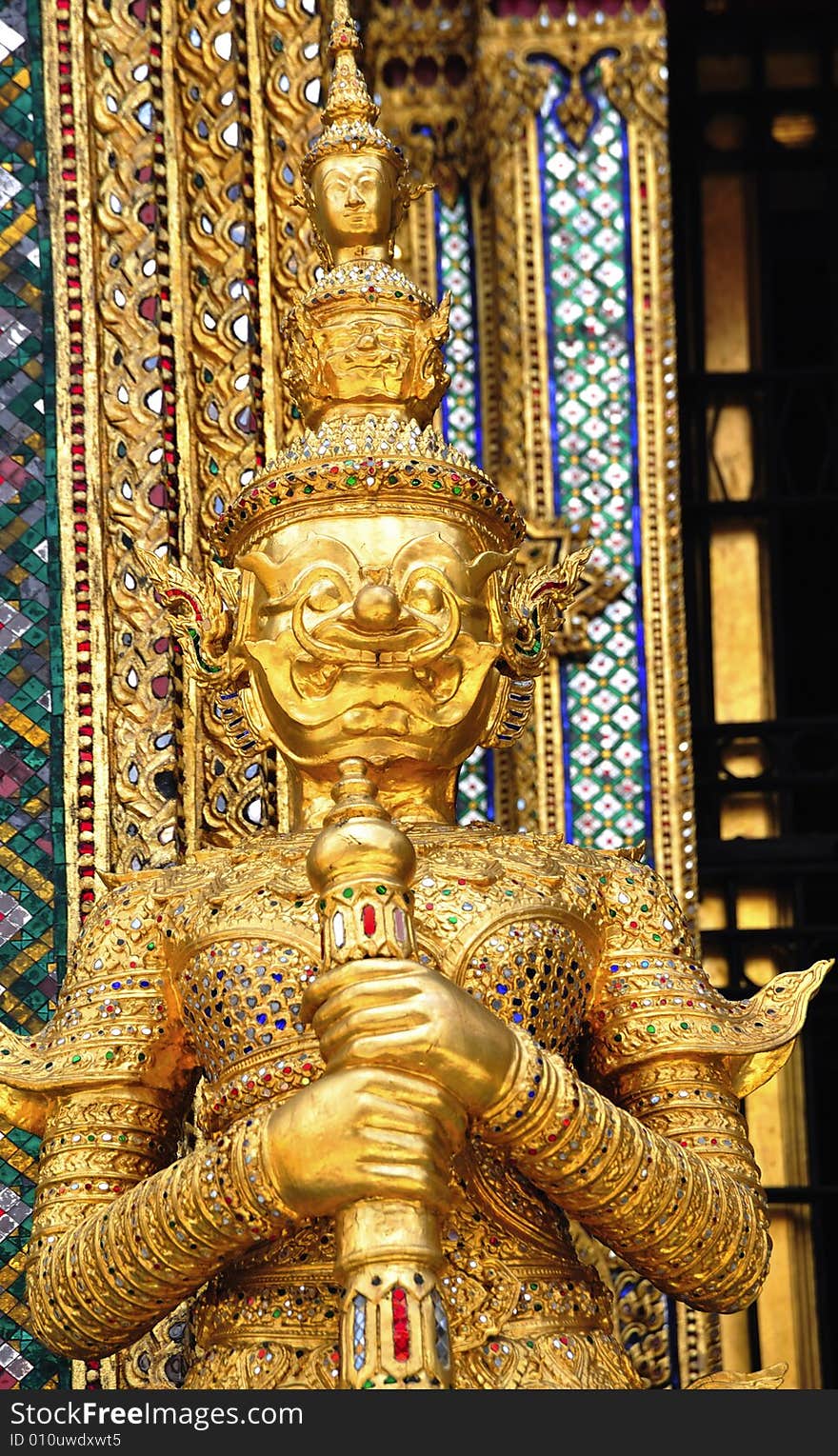 Thailand Bangkok; the wat Phra Kaew shelter the most sacred image of Thailand the Emerald Buddha. The temple is situated in the northeast corner of the Grand Palace. View of a guardian statue or yakshas. Thailand Bangkok; the wat Phra Kaew shelter the most sacred image of Thailand the Emerald Buddha. The temple is situated in the northeast corner of the Grand Palace. View of a guardian statue or yakshas