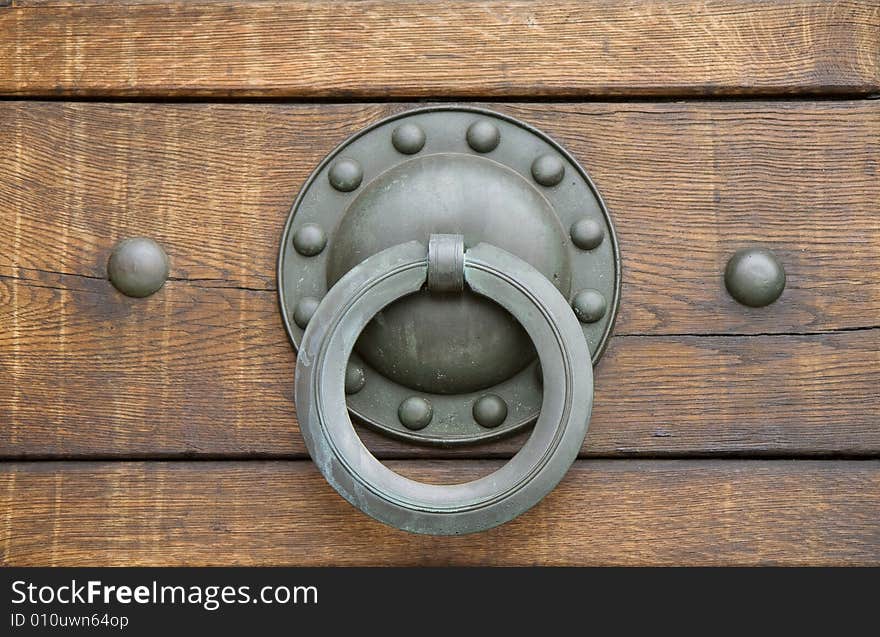 Small door handle made of brass on a church door