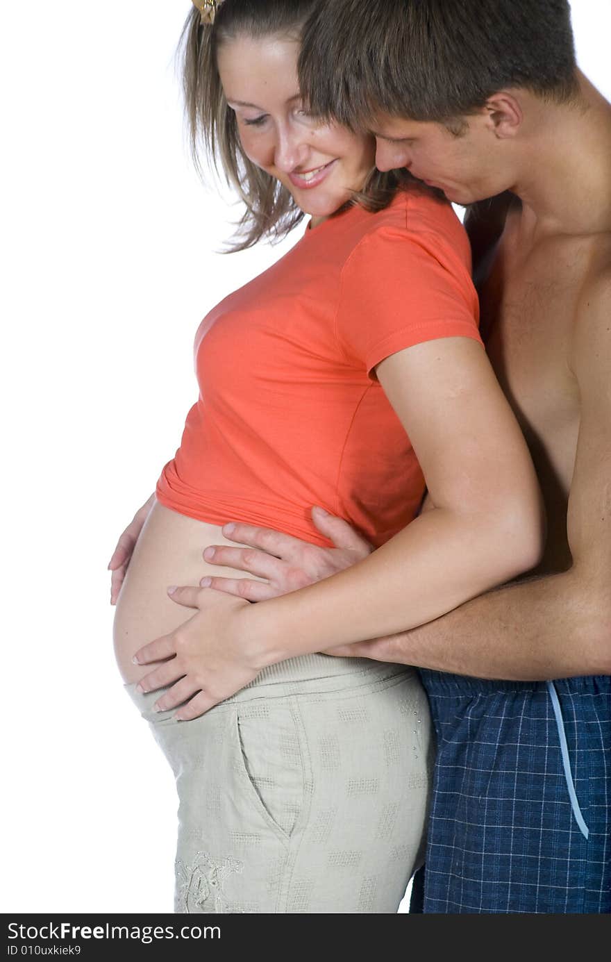 The young couple are waiting for their own baby against white background. The young couple are waiting for their own baby against white background