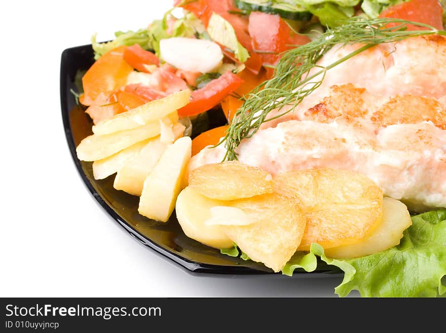 Stake from a salmon with vegetables on a plate. Closeup.