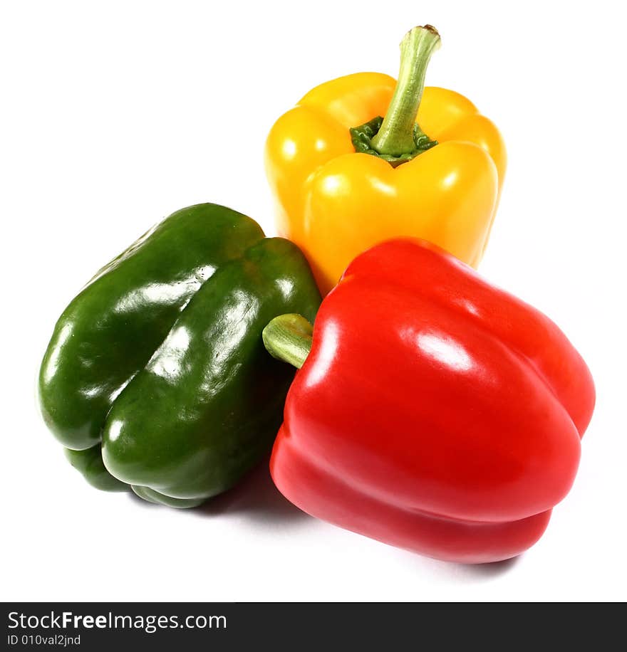 Red, yellow and green paprika on white background