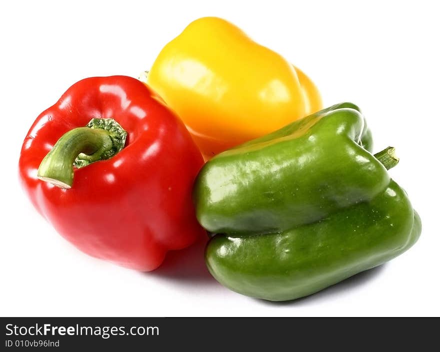 Red, yellow and green paprika on white background