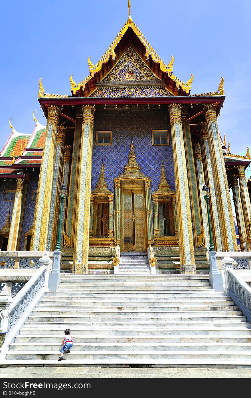 Thailand Bangkok; the wat Phra Kaew shelter the most sacred image of Thailand the Emerald Buddha. The temple is situated in the northeast corner of the Grand Palace. View of one entrance door. Thailand Bangkok; the wat Phra Kaew shelter the most sacred image of Thailand the Emerald Buddha. The temple is situated in the northeast corner of the Grand Palace. View of one entrance door