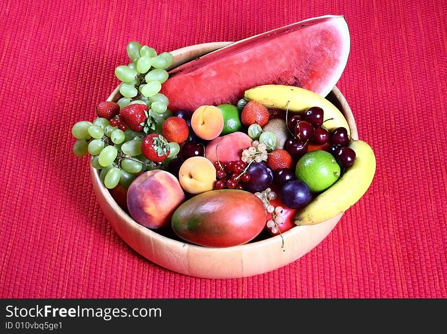 Fresh fruit on red background