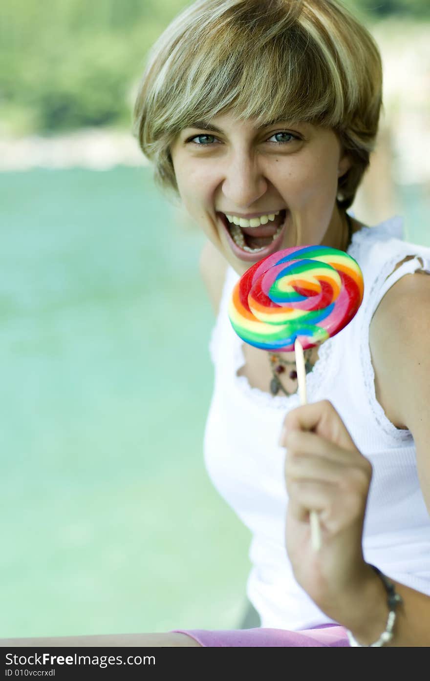 A nice lady singing with a lollipop