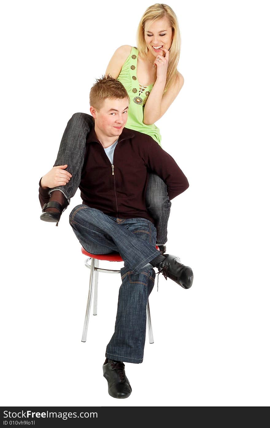 A Joyful couple sitting on a chair, isolated on white