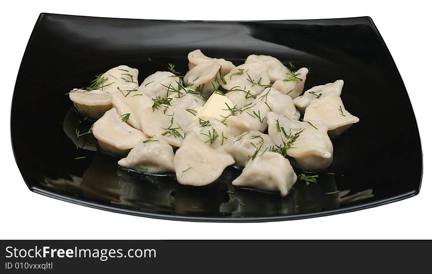 Dumplings with butter and dill on the black plate