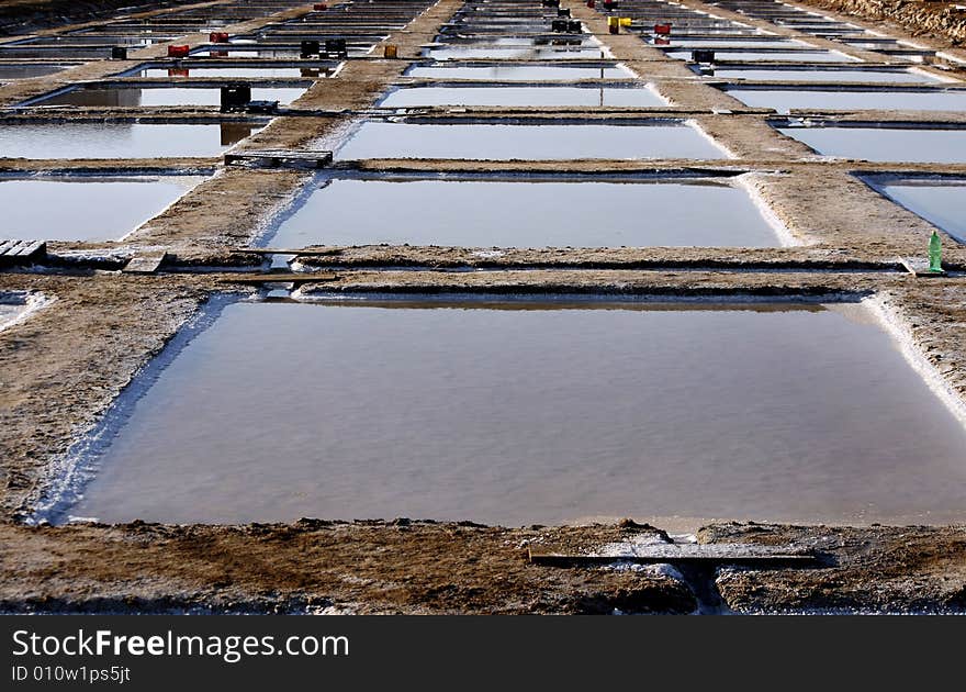 Many saline exploration squares holding water near Olhão, Portugal. Many saline exploration squares holding water near Olhão, Portugal.