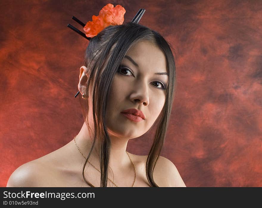 Beautiful young asiatic girl with red poppies against red. Beautiful young asiatic girl with red poppies against red