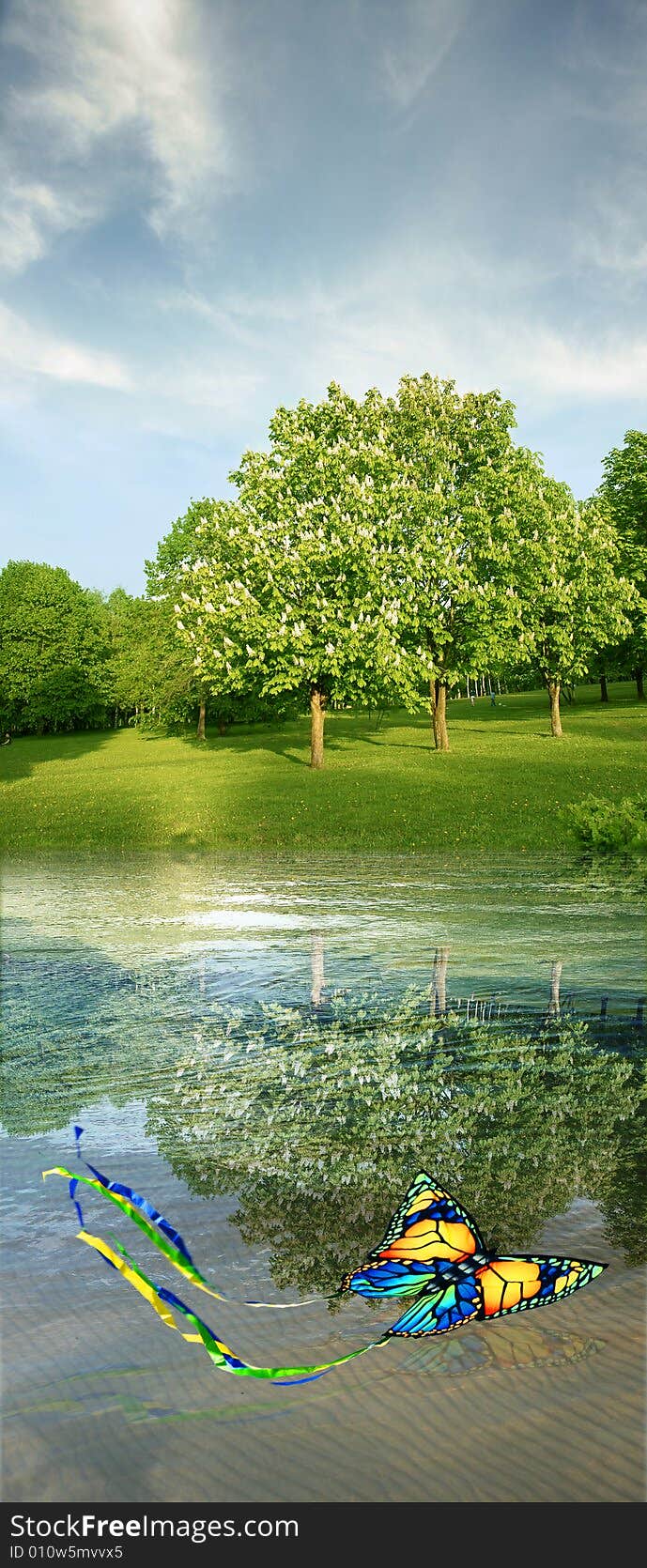 Summer landscape with butterfly kite, blooming horse-chestnuts, water & sky