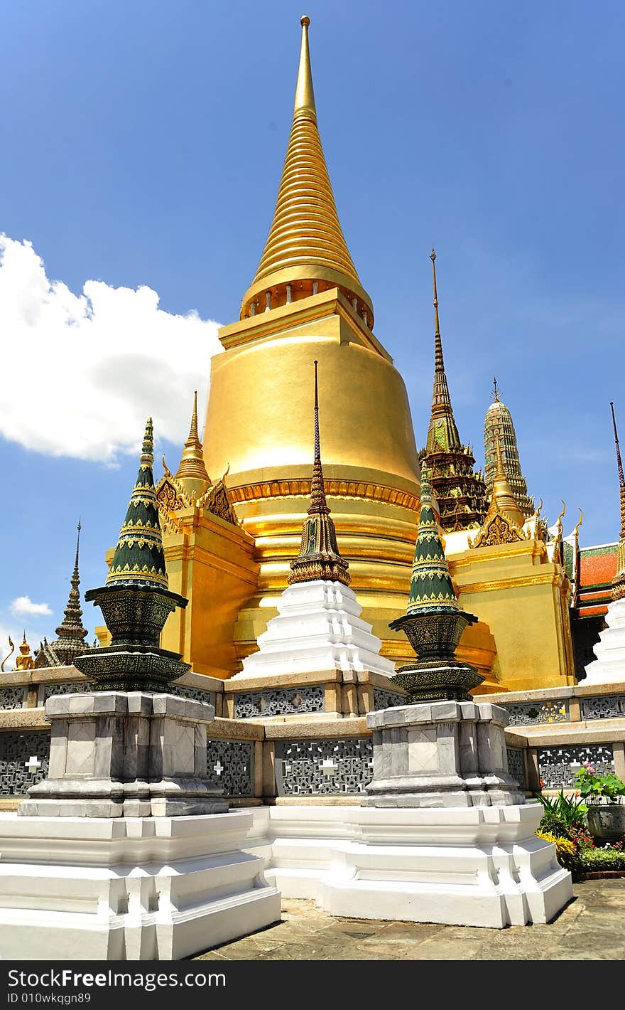 Thailand Bangkok; the wat Phra Kaew shelter the most sacred image of Thailand the Emerald Buddha. The temple is situated in the northeast corner of the Grand Palace. View of the golden stupas and phra. Thailand Bangkok; the wat Phra Kaew shelter the most sacred image of Thailand the Emerald Buddha. The temple is situated in the northeast corner of the Grand Palace. View of the golden stupas and phra