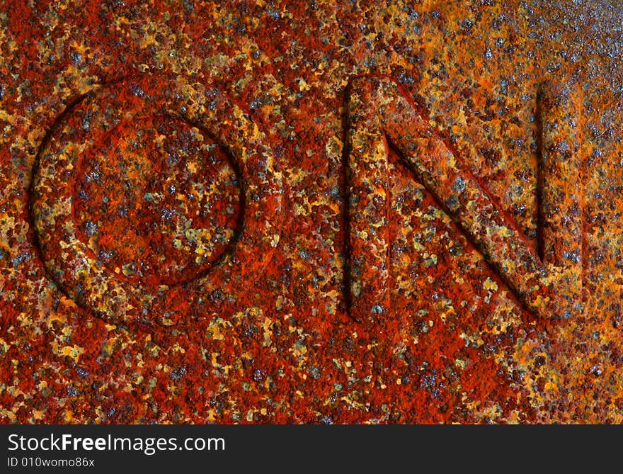 Macro image of an on sign covered in rust. Macro image of an on sign covered in rust