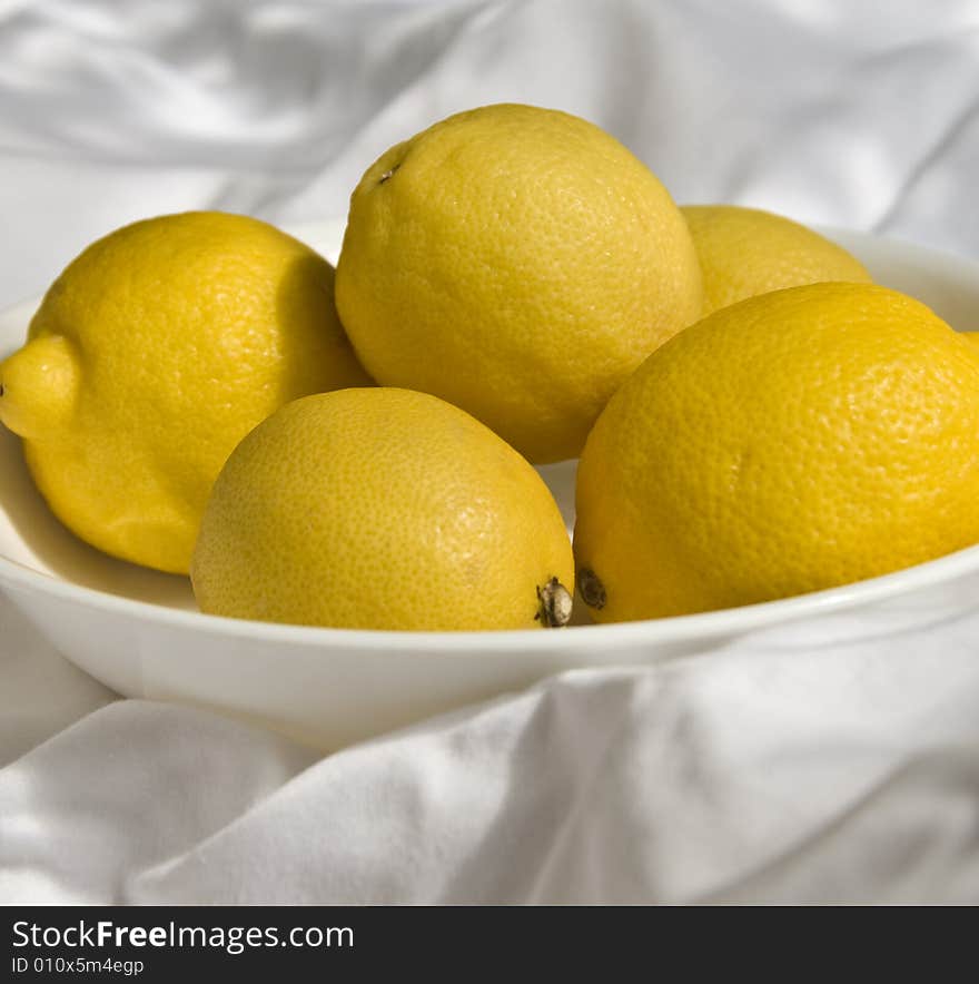 A bowl of bright yellow lemons. A bowl of bright yellow lemons.