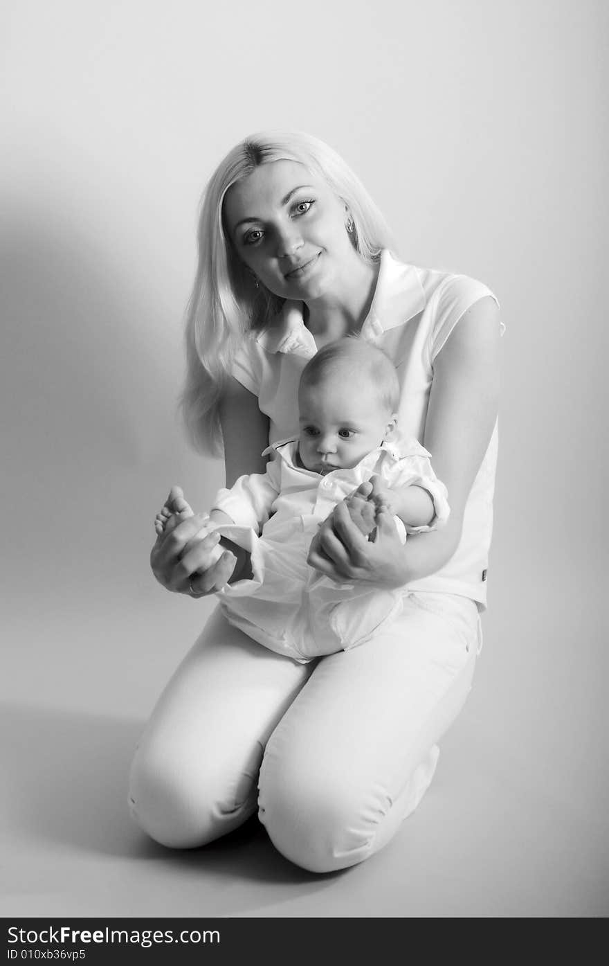 Black and white portrait of happy mother with baby