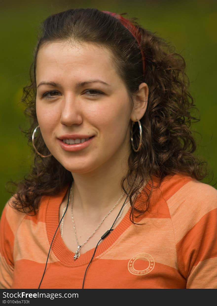 Smiling Girl Outdoors on Green Background