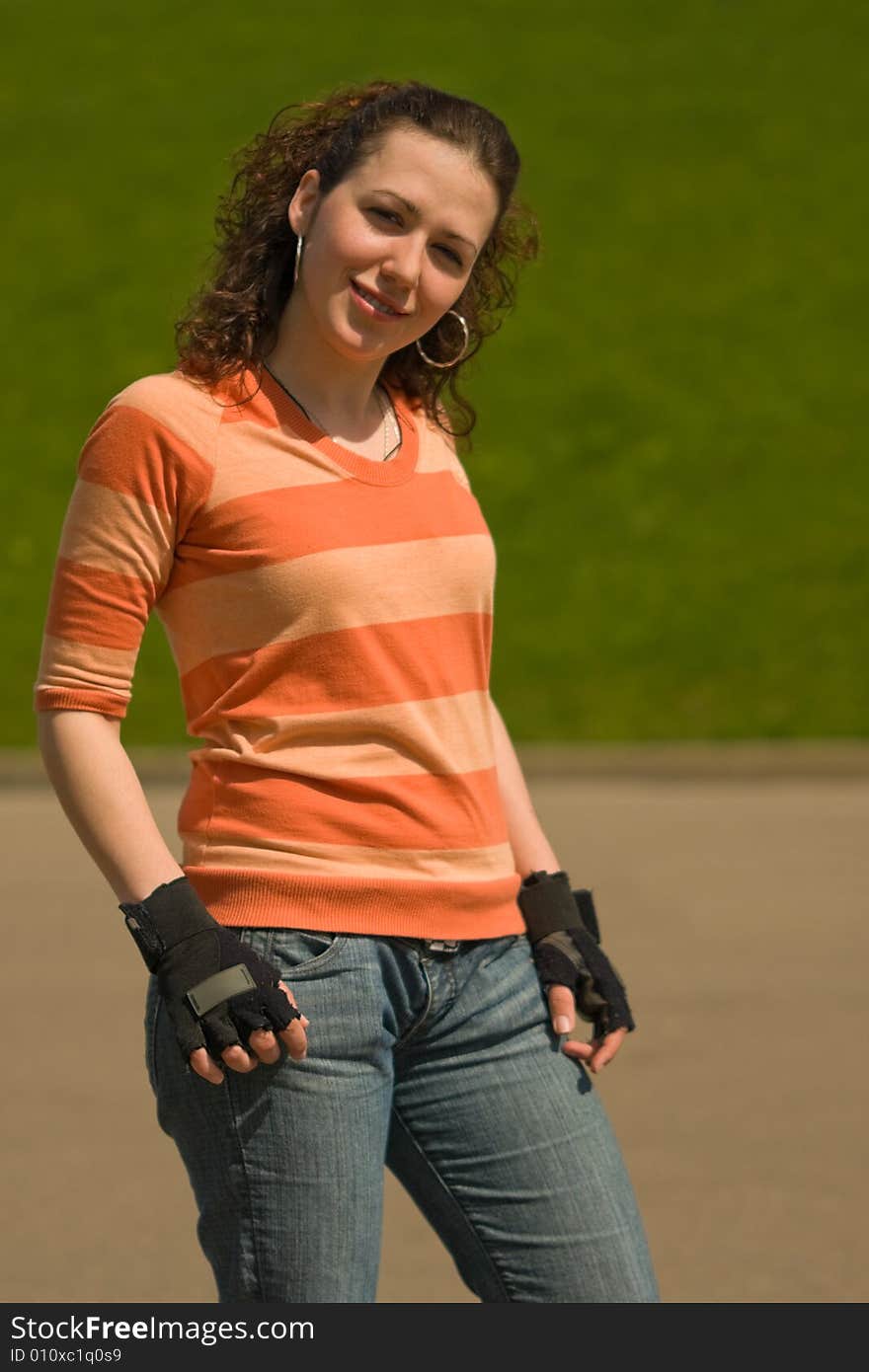 Smiling Sports Girl Outdoors on Green Background