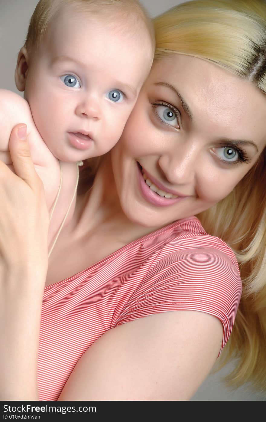 Young happy smiling mother holds her baby. Young happy smiling mother holds her baby