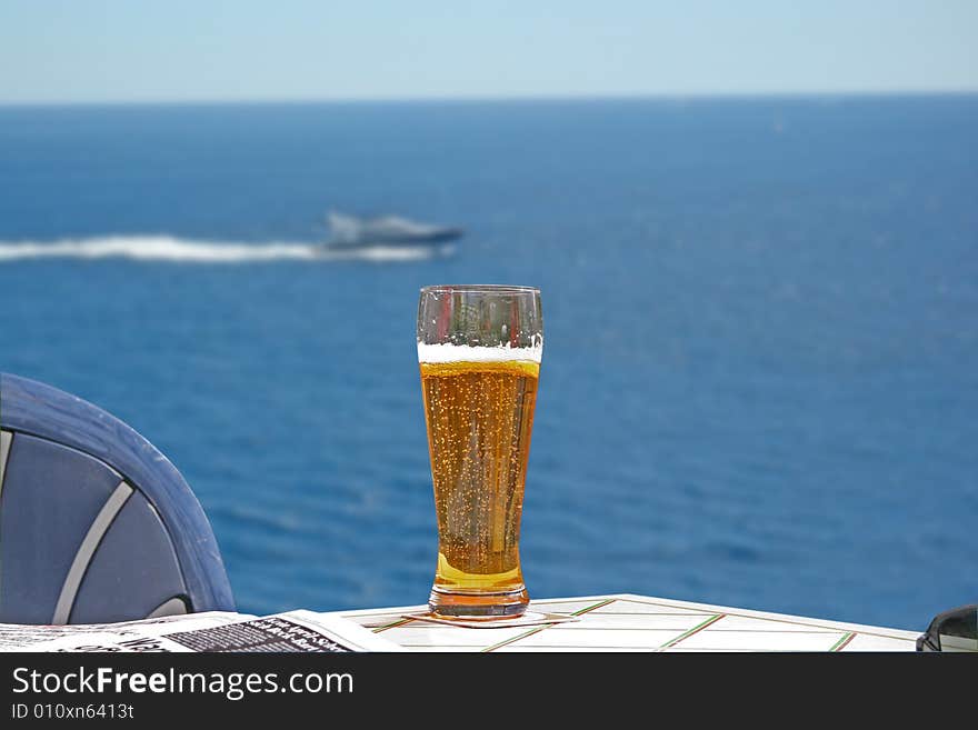 Glass of beer in the restaurant by the sea. Glass of beer in the restaurant by the sea