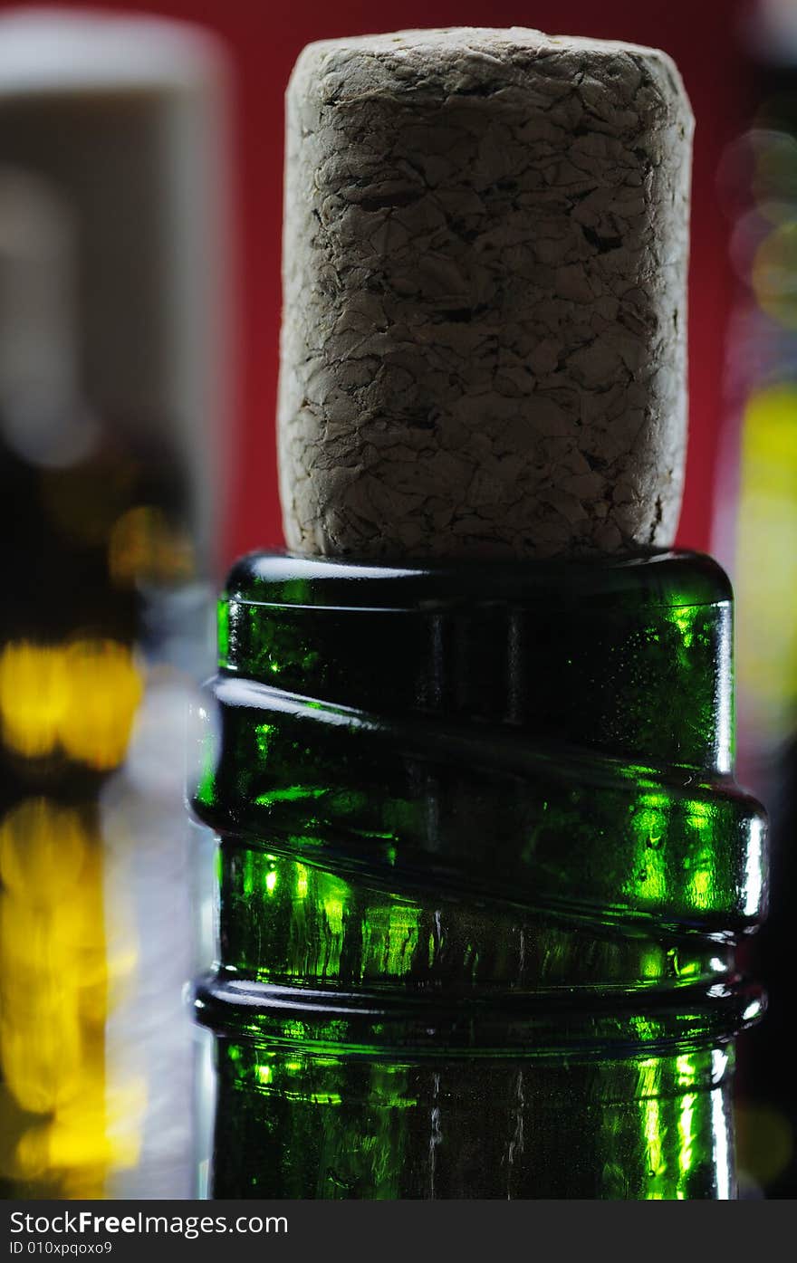 Wine bottles on the red background. Narrow depth of field. Wine bottles on the red background. Narrow depth of field.